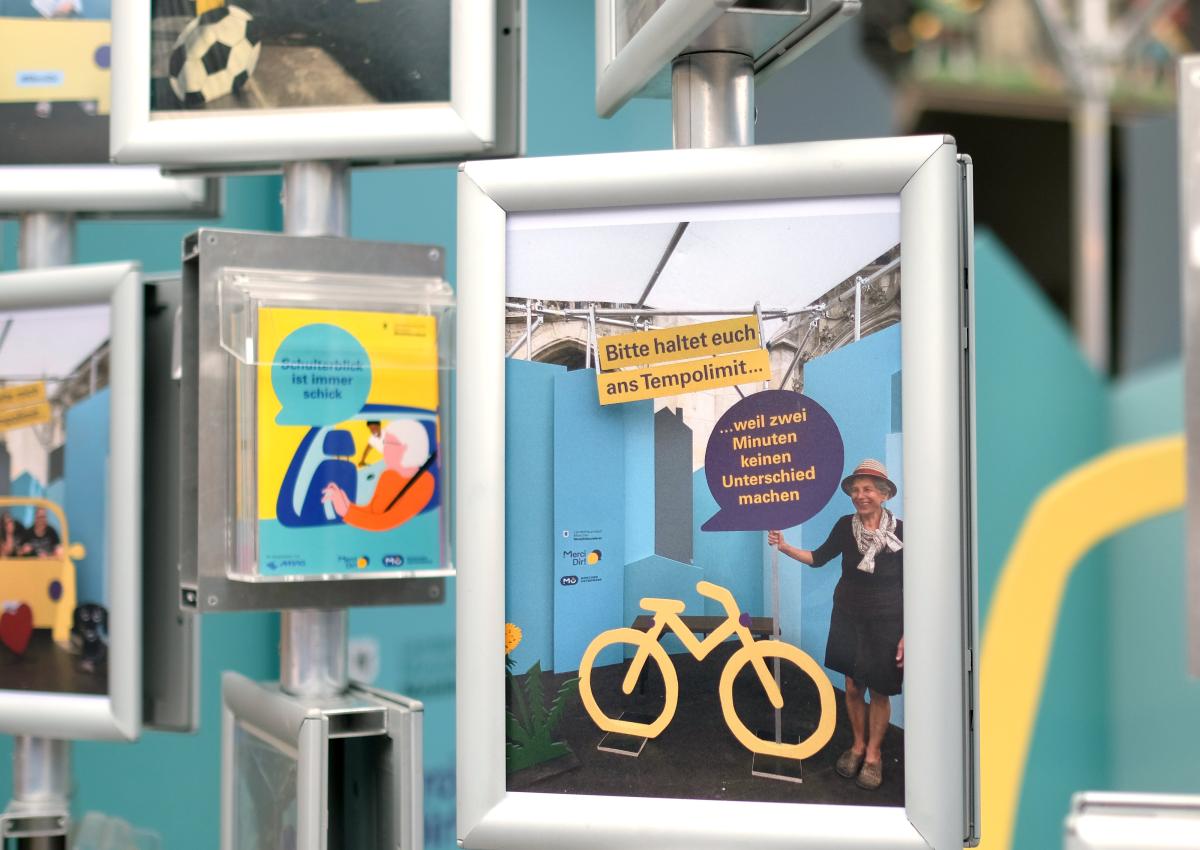 Eine Fotokachel des Pop-up-Fotostudios von Merci Dir, auf der eine Frau neben einem Holzfahrrad zu sehen ist